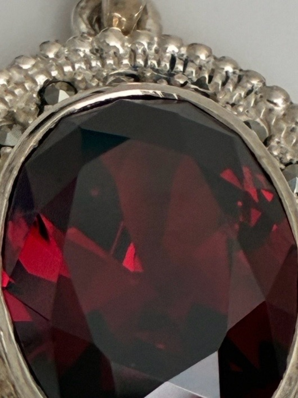 Elegant Silver Pendant with Deep Red Faceted Stone